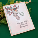 Christmas card with a mouse and candy cane design, surrounded by greenery.