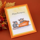 Thanksgiving card with two mice eating a pie on an orange background