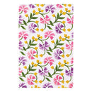 A rectangular white fabric item, likely a tea towel or kitchen towel, featuring a colorful watercolor floral pattern with pink, purple, and yellow flowers and green leaves.