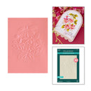 Floral embossing folder, card with floral design, and Spellbinders packaging on a white background