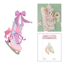 A craft kit featuring a pink and lavender ice skate illustration, a decorated embellished shoe kit on a mint green background, and a package labeled 'Anchors Aweigh' with 'Cutting Dies' on a white background.