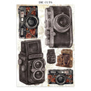 A sheet of die-cut stickers featuring vintage camera illustrations, including black-and-white and sepia models with floral rose accents, on a light background with the text 'DIE CUTS' at the top.