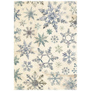 Patterned paper with blue and green snowflake designs on a beige background