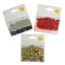 Three packages of craft sequins on a white background: one silver and black, one red and light pink, and one gold.