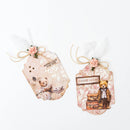 Two decorative gift tags with teddy bears and floral elements on a white background