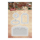 Studio Light cutting dies sheet for Christmas labels, featuring four gray metal die shapes on a beige plaid background with a Christmas-themed header card.