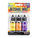 A 3-pack of Ranger Tim Holtz Alcohol Inks in a blister pack. The set includes three bottles of multi-color dyes: gold, orange, and purple, with black caps, set against a colorful watercolor background on the card.