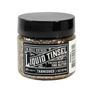 A jar of Tim Holtz Distress Liquid Tinsel Tarnished Vintage Metallic Fine Glitter, 1 oz / 29 ml, featuring a black lid and a black-and-white label on a white background.
