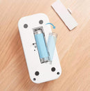 White electronic device with blue components on a wooden surface