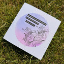 Card with floral design and Chinese proverb on grass