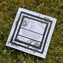 Card with floral design and text on grass