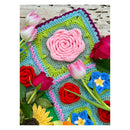 Crochet flowers on a blanket wooden backround