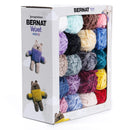 Box of Bernat Velvet minis yarn with colourful skeins and knitted toys on a white background