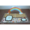 Pop-up card with a rainbow, bear, and paw prints on a brown surface.