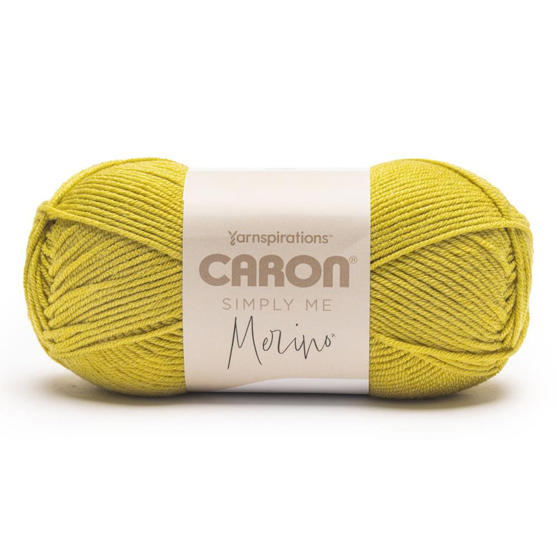 Ball of yellow yarn with Caron label on a white background