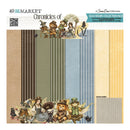 A scrapbook paper collection pack titled '49th and Market Chronicles of Oz' by Cherrie Lane Collection. The pack features multiple patterned sheets in beige, brown, green, blue, and yellow, decorated with vintage illustrations of Oz characters like Dorothy, the Cowardly Lion, and Tweedledee.