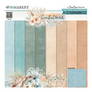 A 12x12" solid paper collection pack titled 'Coastal Soul' by 49th & Market, featuring six textured paper sheets in shades of teal, sage green, cream, and peach, decorated with seashells, flowers, and a sea turtle illustration.