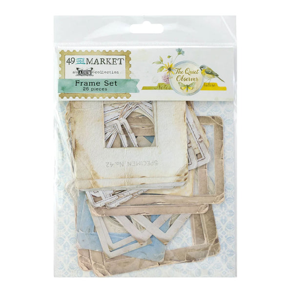 A packaged set of vintage-style scrapbook frame pieces from 49 and Me Market by The Quiet Clover Studio. The clear plastic bag shows a collection of layered, distressed paper frames in beige, cream, and light blue tones.