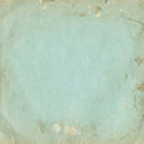 A square textured tile or coaster with a distressed, vintage paper appearance in a pale mint green color with brown and beige creases and peeling details.