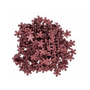 A pile of small dusty Mauve flower-shaped embellishments or confetti on a solid white background.