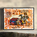 A framed mixed-media art print featuring a stack of colorful books and a large yellow-orange flower on an abstract orange, brown, and cream background with handwritten notes and musical staves. The print is displayed on a rustic wooden surface against a soft beige background.