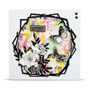 A square white card or plaque featuring a collage-style floral and butterfly design. The artwork includes black line-drawn flowers, black-and-white butterflies, black abstract frame shapes, a small black label reading “Happiness,” and a multicolored mixed-media background with pink, yellow, purple, green, and blue scribbles and text.