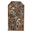 A rectangular decorative plaque or art print with a distressed brown background, featuring embossed-style floral magnolia branches in cream and beige tones over abstract lettering.