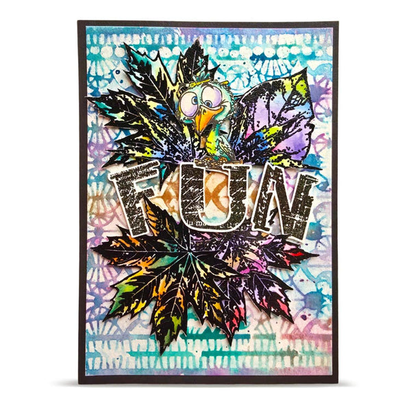 A colorful mixed-media art card featuring a cartoon owl surrounded by layered black and multicolored leaves, with the word 'FUN' across the center, shown against a plain white background.