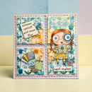 A handmade square greeting card featuring a whimsical cartoon girl holding a card that reads 'card maker,' with decorative text panels and craft-themed embellishments. The card is photographed standing upright on a pale surface against a softly pastel background.