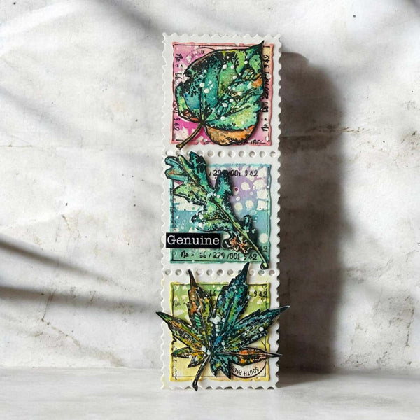 Three vintage-style postage stamp designs stacked vertically, each featuring a distressed, metallic green leaf on colorful paper backgrounds, displayed against a textured off-white wall with soft leaf shadows.