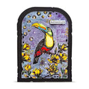 A square art print or decorative plaque with an arched top, featuring a colorful toucan perched among yellow flowers on a purple textured background with bubble and postmark-style details. The word 'Adventure' appears near the toucan.