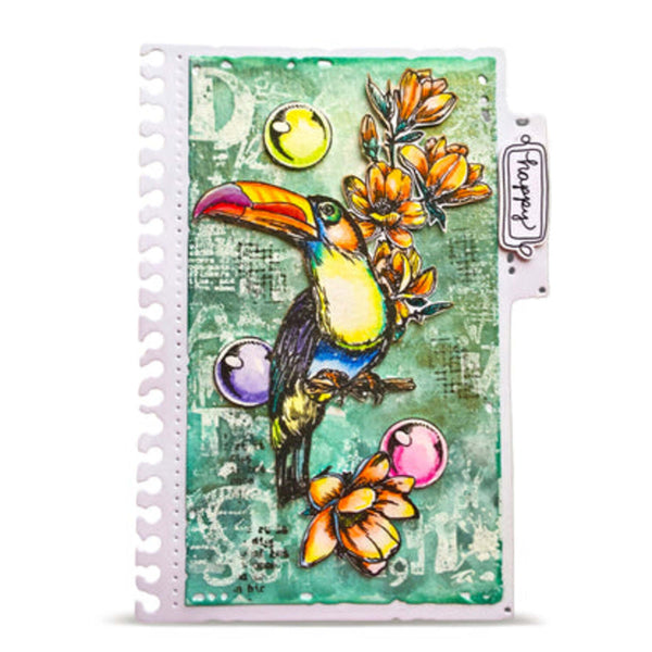 A spiral-bound art journal or planner with a colorful collage-style cover featuring a toucan, flowers, and abstract teal background. A hanging tag on the right reads 'forty four'.