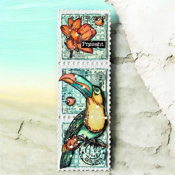 A vertical rectangular stamp or card design featuring a colorful toucan and orange flower on a distressed teal background, with a white scalloped border, shown against a beach-like backdrop with turquoise water and pale sand.