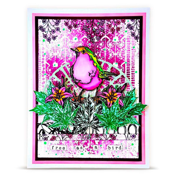 A square layered card featuring a vibrant pink bird perched among green leaves and pink flowers, set against a busy pink and white patterned background with the words 'free as a bird' at the bottom.
