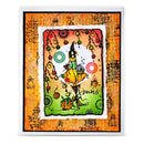 A square handmade greeting card featuring a whimsical witch illustration. The central artwork shows a witch in a pointed black hat and yellow dress flying a yellow sailboat on a green and peach background with hanging ornaments and the word 'Kmas'.