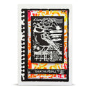 A square layered scrapbook card featuring a black and white bird silhouette stamp design over a vibrant orange, yellow, and white abstract splatter background, framed by a white border.