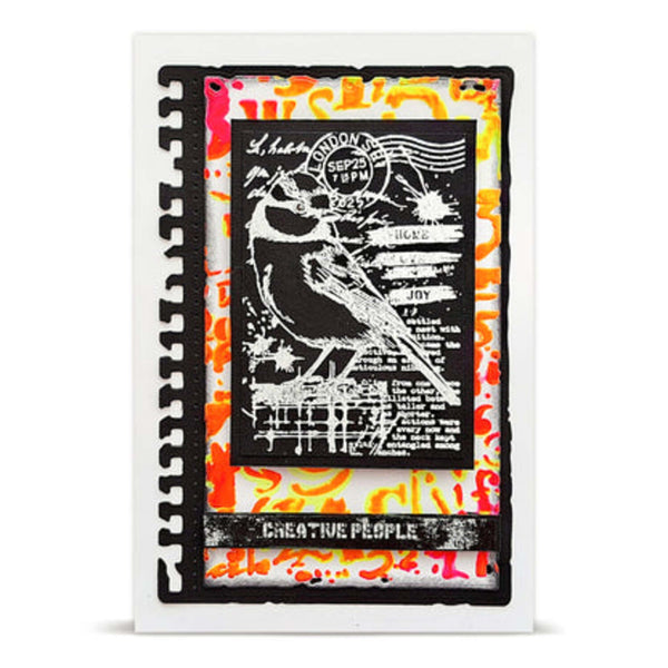 A square layered scrapbook card featuring a black and white bird silhouette stamp design over a vibrant orange, yellow, and white abstract splatter background, framed by a white border.