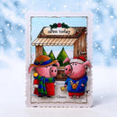 A handmade Christmas greeting card featuring two cartoon pigs in winter clothing standing in front of a shop with an 'Open today' sign. The card has a scalloped white border and is displayed against a snowy, blue-toned background with falling snowflake graphics.