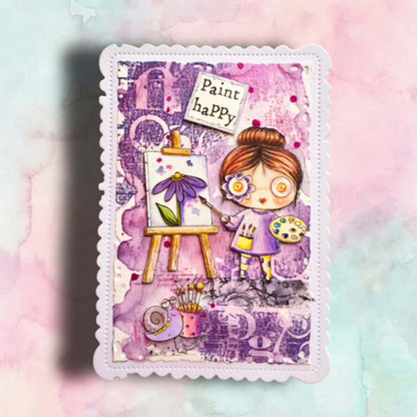 A square mixed-media art card featuring a whimsical illustration of a girl painting at an easel, surrounded by purple and pink abstract textures, with the words 'Paint happy' on a torn paper label. The card has a scalloped white border and is photographed against a pastel pink and mint watercolor background.