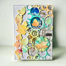 Decorative notebook cover with colorful leaf and circular designs on a light background