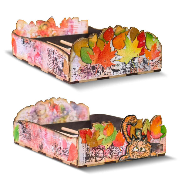 Two cardboard hats with autumn leaf and animal designs on a white background