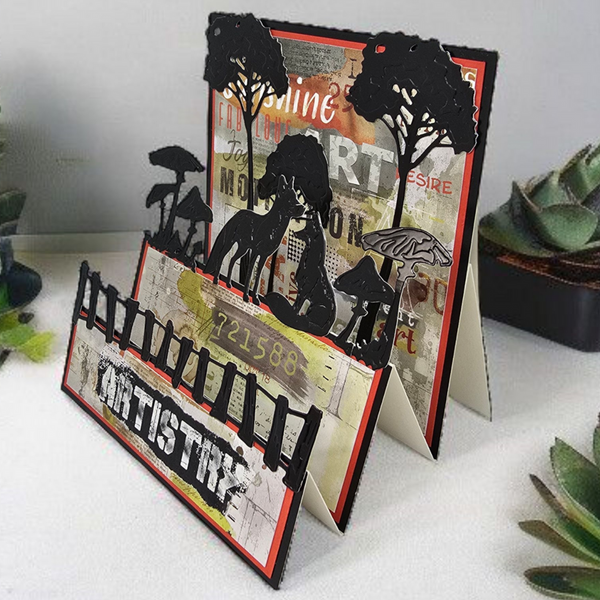 Decorative card with cut-out silhouettes of people and trees on a textured surface.