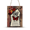 Decorative sign with butterflies and leaves on a wooden background