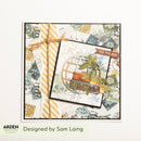 A handmade travel-themed card featuring vintage postage stamps, miniature suitcases, a globe motif, and a yellow-and-white striped ribbon. The card is displayed on a white background with the text 'Designed by Sam Laing' and the Arden Creative Designs logo at the bottom.