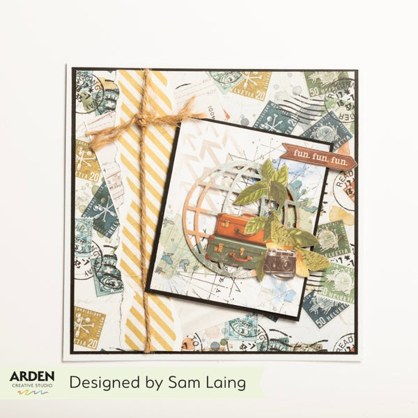A handmade travel-themed card featuring vintage postage stamps, miniature suitcases, a globe motif, and a yellow-and-white striped ribbon. The card is displayed on a white background with the text 'Designed by Sam Laing' and the Arden Creative Designs logo at the bottom.