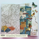 An open handmade journal spread showing two decorated pages with vintage map artwork, layered paper textures, butterflies, small labels, and decorative elements. A banner at the bottom reads 'Designed by Christine Smith' with the Arden Handmade logo.