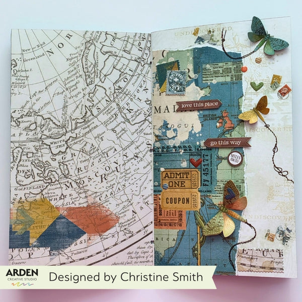 An open handmade journal spread showing two decorated pages with vintage map artwork, layered paper textures, butterflies, small labels, and decorative elements. A banner at the bottom reads 'Designed by Christine Smith' with the Arden Handmade logo.