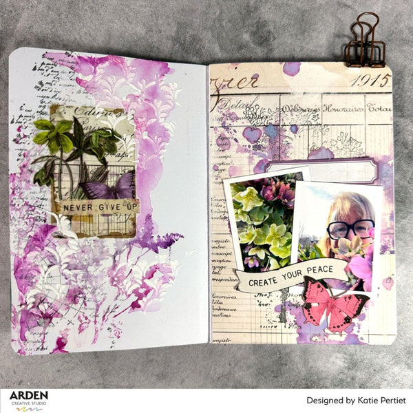 Open notebook with floral and vintage design elements on a gray background
