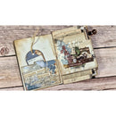 An open vintage-style collage journal or scrapbook album laid flat on a rustic wood plank surface. The pages are aged cream with layered collage elements including maps, postmarks, handwritten notes, small illustrations, and a hanging string tag.