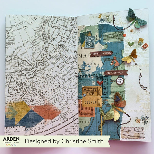 An open handmade journal spread showing two decorated pages with vintage map artwork, layered paper textures, butterflies, small labels, and decorative elements. A banner at the bottom reads 'Designed by Christine Smith' with the Arden Handmade logo.